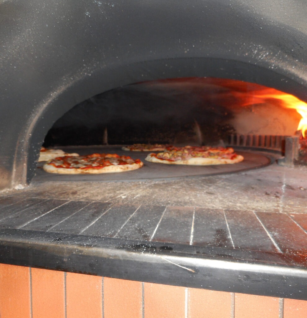 Pizzas en cuisson sur une sole rotative de four